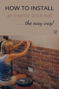 a woman is painting a brick wall with the words how to install an interior brick wall