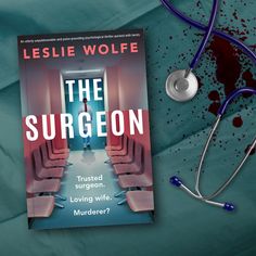 the surgeon book and stethoscope laying on top of a bed with blood splattered walls