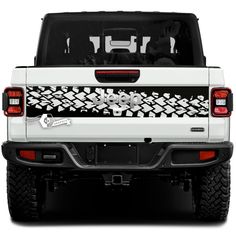 the back end of a white truck with black and white designs on it's bumper