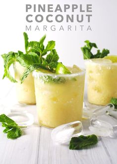 pineapple coconut margaritas with mint garnishes on the rim and in glasses