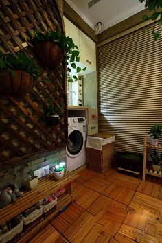 a washer and dryer in a small room with wooden flooring on the walls