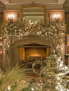 a living room filled with furniture and a fire place covered in christmas decorations next to a fireplace