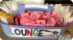 a blue container filled with lots of pink tissues and spoons next to a pile of toilet paper