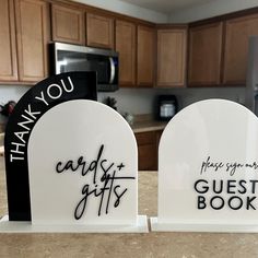 two white heart shaped bookends with thank you and guest books written on them