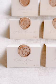 wedding place card holders with coins on them for guests to take home from the ceremony