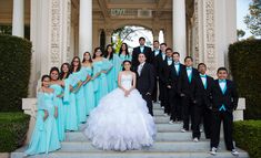 a group of people in formal wear standing on steps