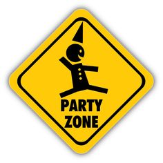 a yellow party zone sign with a person doing a trick on it's back