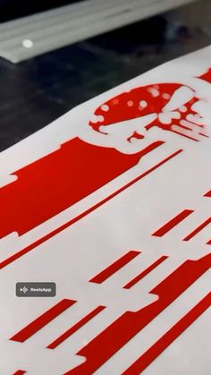 a red and white sign sitting on top of a table