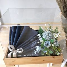 an arrangement of flowers and napkins in a display case