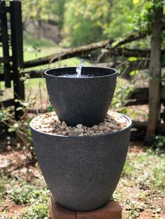 three tiered planters with water coming out of them