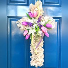 a blue door with a purple and white cross hanging on it's side next to a sign that says poshmark