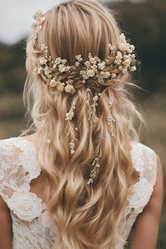 a woman with long blonde hair wearing a flowered headpiece in the middle of her hair