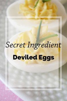 two deviled eggs on a white plate with the words secret ingredient deviled eggs