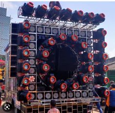 the stage is set up with many speakers on it and people standing in front of it