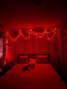 a bed in a room with red lights on the wall