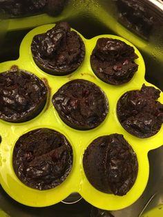 chocolate muffins sitting in a yellow pan on the stove top, ready to be cooked