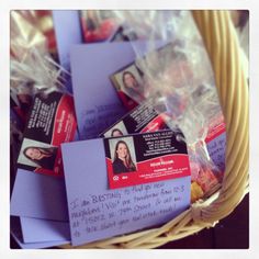 a basket filled with lots of purple envelopes and some pictures on it's side