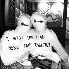 two people sitting next to each other in front of a sign that says i wish we had more time together