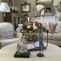 a living room filled with furniture and candles