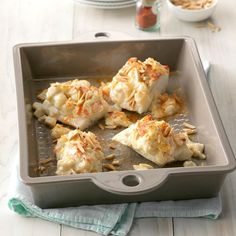 a pan filled with food on top of a wooden table