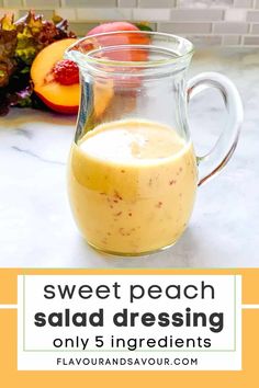 a glass pitcher filled with liquid sitting on top of a counter next to sliced peaches