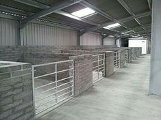 an empty warehouse with brick walls and metal railings