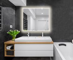 a bathroom with a sink, mirror and bathtub