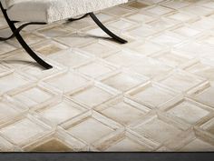 a white bench sitting on top of a tiled floor