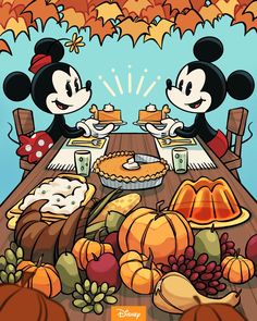 two mickey mouses sitting at a table with food