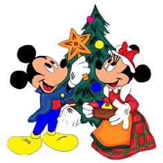 two mickey mouses standing next to each other near a christmas tree