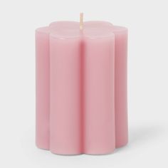 three pink candles with a single candle sticking out of the middle