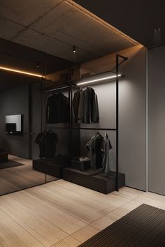 an empty room with clothes on display in it