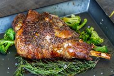 a piece of meat and some broccoli on a pan