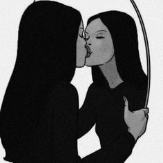 two women are kissing each other in front of a mirror with the reflection of them