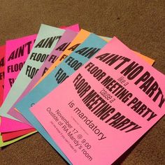 five different colored paper flyers sitting on the floor next to each other with words printed on them