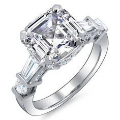 an emerald cut diamond ring with three baguets