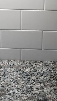 a close up of a counter top with a tile wall in the backround