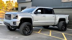 a silver truck parked in front of a building