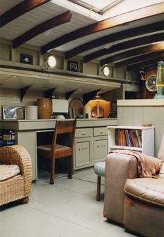 a living room filled with furniture next to a kitchen