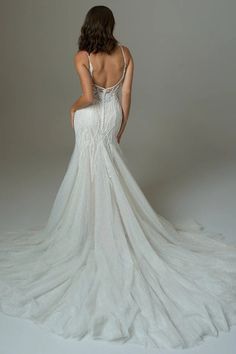 a woman in a white wedding dress is standing back to back with her hands on her hips