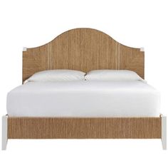 the headboard and foot board of a bed with white sheets, pillows and linens