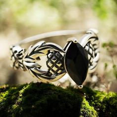 This stunning vintage ring features a Scottish thistle design with a marquise-cut natural black agate stone set in high-quality 925 sterling silver. The stone measures 10x5mm and the ring is stamped with the 925 purity mark, indicating its genuine sterling silver composition. Ideal for those who appreciate unique and meaningful jewelry pieces. Black Agate Stone, Thistle Design, Scottish Thistle, Jewelry Beautiful, Meaningful Jewelry, Celtic Jewelry, Black Agate, Ring Unique, Friendship Gifts