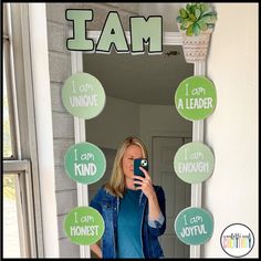 a woman taking a selfie in front of a mirror with stickers on it