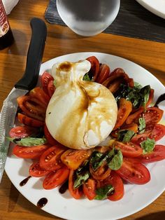 a white plate topped with lots of tomatoes