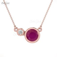 Description The round Ruby looks stunning, especially when paired with a magnificent round diamond on the side. This necklace, made of gleaming 14K pure gold, provides the right touch of glitz to your ensemble. The stones' bezel setting adds a touch of sophistication to this solitaire ruby. Product Details SKU CJ-N-1271-R Metal 14K Solid Gold Chain type Cable Chain Chain length 14+2 inch Closing mechanism Spring Ring Product dimension 16 inch x 13.72mm x 3.13mm Birthstone July Certification - St Ruby Chain, Ruby Diamond Necklace, Tanzanite Rings, Ruby And Diamond Necklace, Bezel Set Necklace, Delicate Necklaces, Solid Gold Necklace, Solid Gold Chains, Ruby Necklace