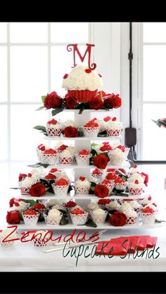 a wedding cake with red and white flowers on it