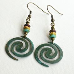 "Boho Spiral Earrings - Lightweight Verdigris Patina Brass Spirals dangle from Turquoise, Tortoise Colored, and Dark Red Czech Glass Beads The spirals are 1\" in diameter (approximately size of US quarter). Antiqued Brass Earwires For other Boho Earrings: https://www.etsy.com/shop/mcstoneworks?search_query=boho+earrings" Nickel-free Spiral Blue Earrings, Unique Turquoise Metal Earrings, Handmade Spiral Turquoise Jewelry, Handmade Turquoise Spiral Jewelry, Green Spiral Earrings As Gift, Unique Spiral Turquoise Jewelry, Patina Jewelry, Silver Dragonfly Necklace, Patina Earrings