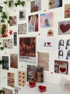 a white refrigerator covered in magnets and pictures next to a potted green plant