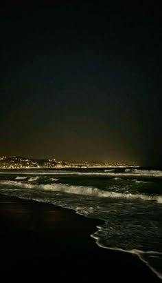 the beach is dark and empty at night with no people on it or in the water