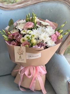 a bouquet of flowers sitting on top of a blue chair